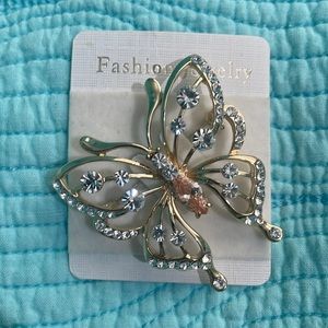Butterfly gold tone pin with stone accents